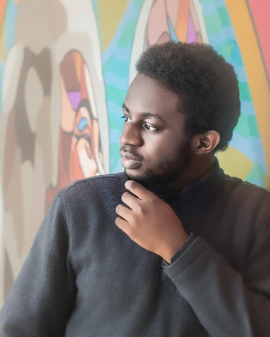 Thoughtful portrait near a window with a colourful background