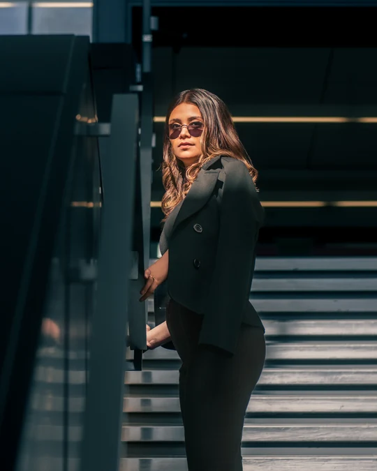 Environmental portrait beside an architectural staircase